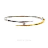 An 18 ct yellow and white gold, diamond solitaire bracelet