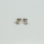 A boxed pair of 14 ct white gold and diamond solitaire, stud earrings