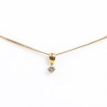 A boxed, 18 ct yellow gold and diamond solitaire pendant on 9 ct chain