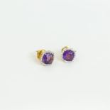 A boxed pair of 18 ct yellow gold, amethyst and diamond, cluster earrings