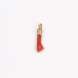 An antique, yellow gold mounted, natural coral, carved-hand, pendant