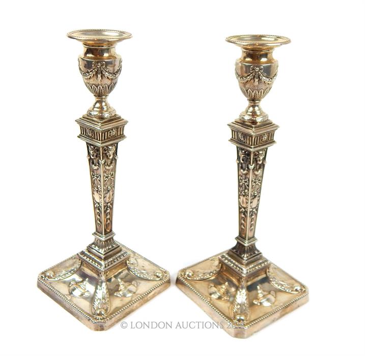 A pair of Victorian Adam Revival sterling silver candlesticks, William Hutton & Sons