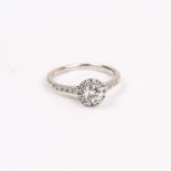 A platinum, Art Deco, brilliant cut diamond solitaire, cluster ring