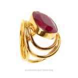 A contemporary, yellow metal and large, natural, faceted ruby ring