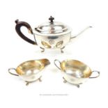 An early 20th century white metal three piece tea set