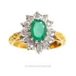 An 18 ct yellow and white gold, natural emerald and diamond cluster ring