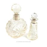 Two cut glass scent bottles with silver collars