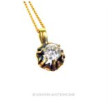 A 9 ct yellow gold, diamond solitaire pendant on a 9 ct chain