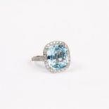 A large, platinum, checker-board-cut blue topaz and diamond cluster ring