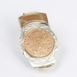 A weighty, silver and rose gold, Aztec-coin style money clip