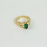 An 14 ct yellow gold, marquise-shaped emerald and diamond ring