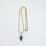 An 18 ct yellow gold, diamond and amethyst pendant and chain