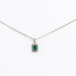 A boxed, 18 ct white gold, emerald and diamond pendant on white gold chain