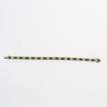 An 18 ct yellow gold, diamond and emerald, tennis bracelet