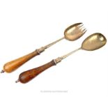 A pair of sterling silver salad servers with oak handles