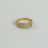 A 9 ct white and yellow gold, diamond, Greek-key design ring