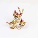 A large, 18 ct yellow gold, flower clip set with rubies and diamonds