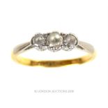 An 18 ct yellow gold and palladium, graduated, three stone diamond ring