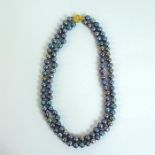 A boxed, 14 ct yellow gold, natural, dark grey pearl, double-strand necklace