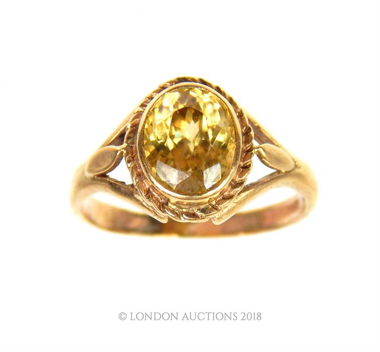 A 9 ct yellow gold and faceted, yellow sapphire ring