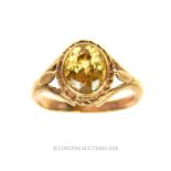 A 9 ct yellow gold and faceted, yellow sapphire ring