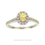 A platinum, fancy-yellow and white diamond cluster ring