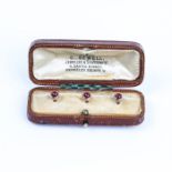 A Victorian, boxed, 9 ct rose gold and garnet cabochon dress studs