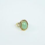 A 14 ct yellow gold, natural, Chinese, green jade cabochon ring