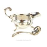 A sterling silver sauce boat and sauce ladle