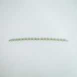 A boxed, 18 ct yellow gold and 18, spherical, polished, green jade, bead bracelet