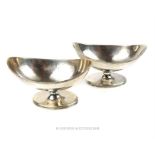 A pair of George III boat shaped sterling silver salts