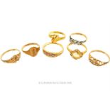 A collection of seven yellow gold ring