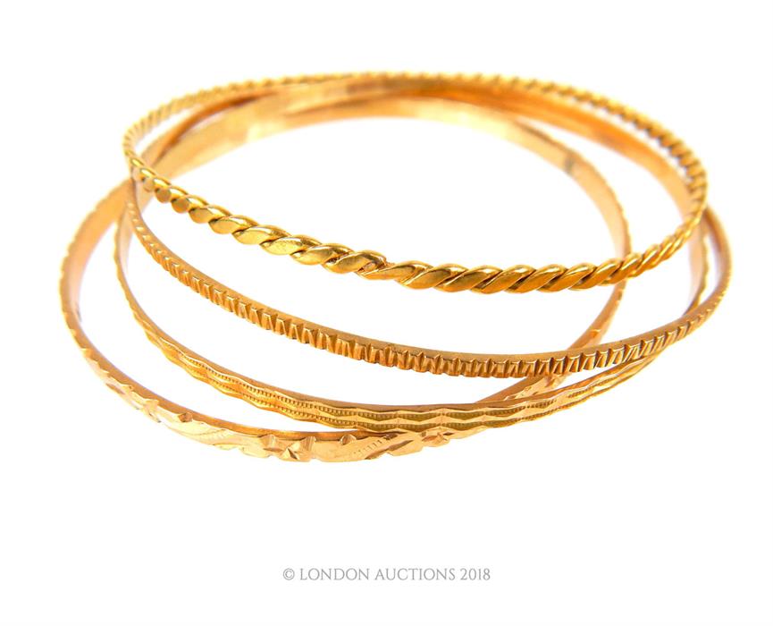 Four, 18 ct yellow gold, engraved bangles