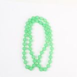 A long strand of natural, Chinese, green jade beads