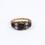 An antique, 9 ct yellow gold, garnet and white opal ring