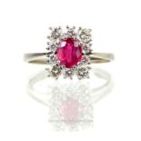 An 18 ct white gold, diamond and ruby cluster ring