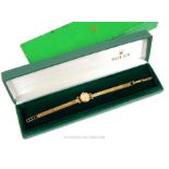 A ladies 9ct gold ladies Rolex wristwatch on a 9ct gold strap