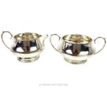 A matching sterling silver milk jug and sugar bowl