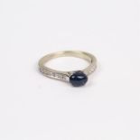 A white gold, diamond and sapphire cabochon ring