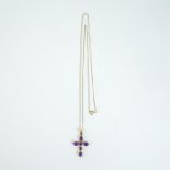 A 9 ct yellow gold, amethyst and diamond studded cross on 9 ct chain