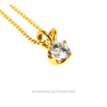 An 18 ct yellow gold, diamond solitaire pendant on an 18 ct yellow gold chain