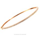 An 18 ct rose gold and diamond bangle by Theo Fennel