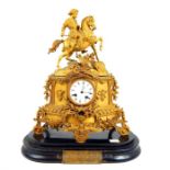 A 19th century gilded spelter mantel clock, surmounted by a figure on horseback