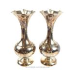 A pair of antique sterling silver, fluted-rim vases