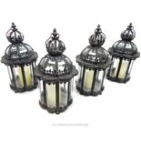 A set of four distressed metal storm lanterns