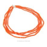 A four strand, coral, beaded necklace