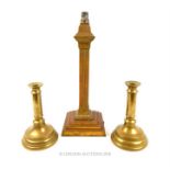 A brass table lamp, together with a pair of brass candlesticks