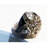 A sterling silver, black enamel, white crystal and marcasite dress ring