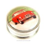 A sterling silver pill box decorated with a classic red, Austin Healy car