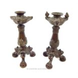 A pair of 19th century classical style cast bronze candlesticks